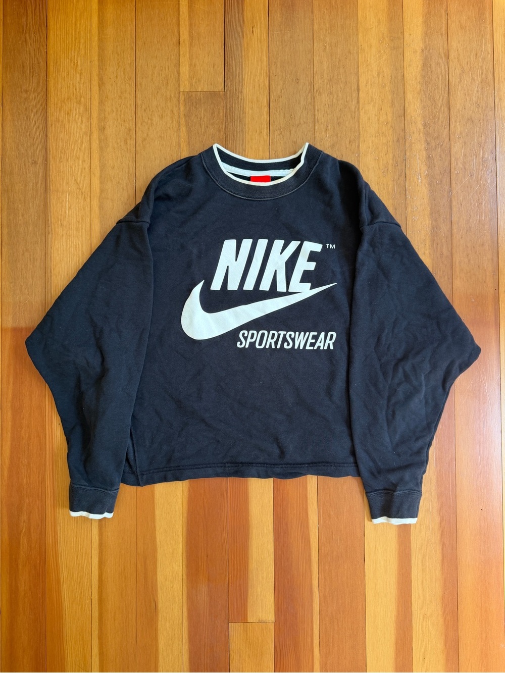 Nike Red and White Logo Clothing Tag on Black Fabric